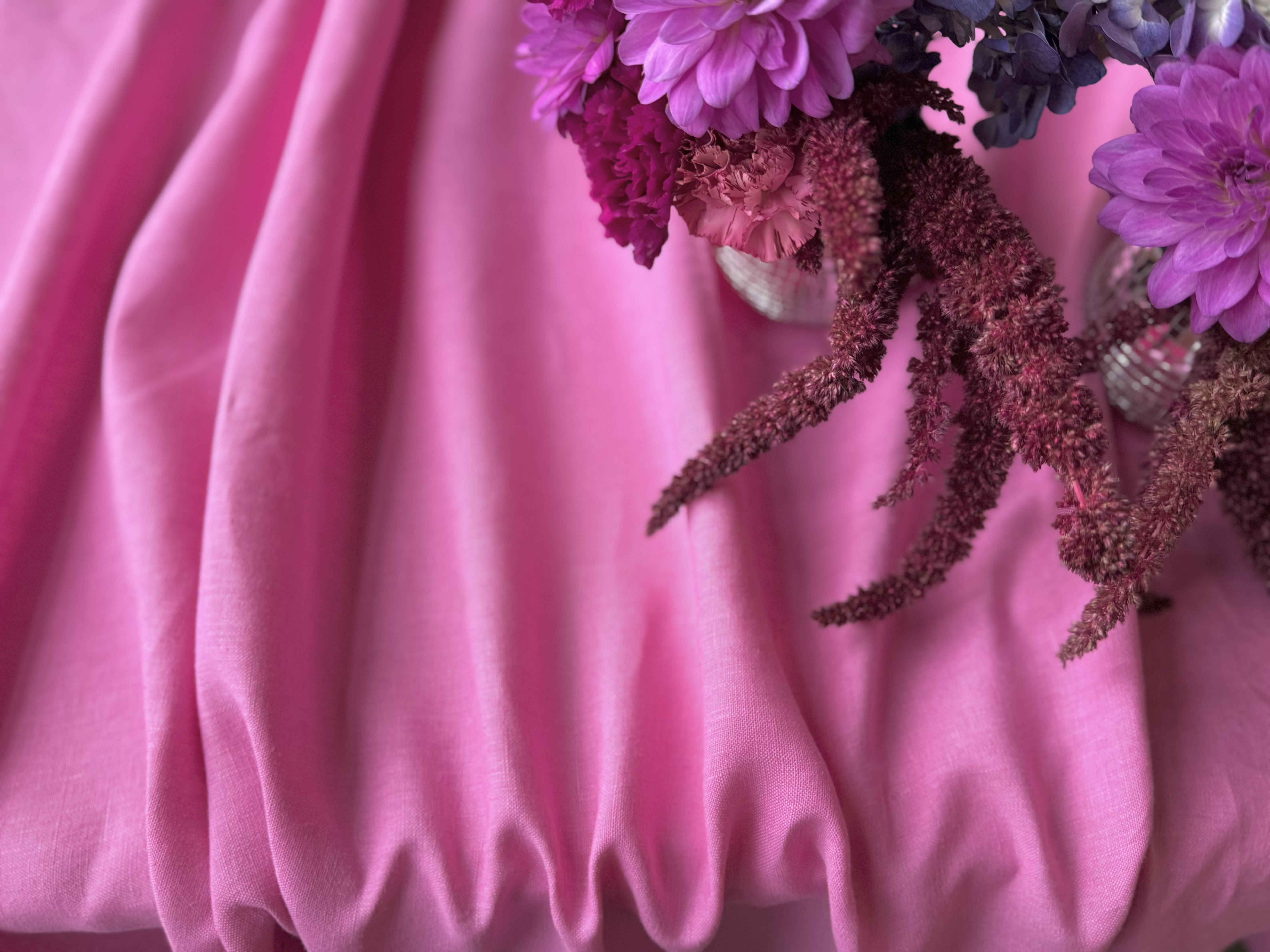 Pink draped fabric with purple and pink floral arrangement by Willa Moore Callahan